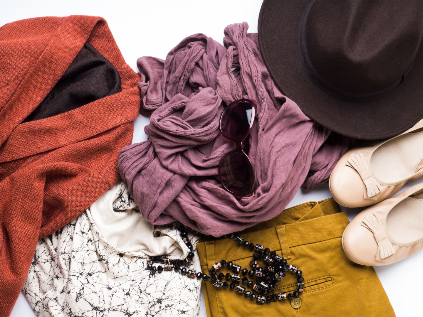 Flat lay with woman’s autumn clothes, glasses hat
